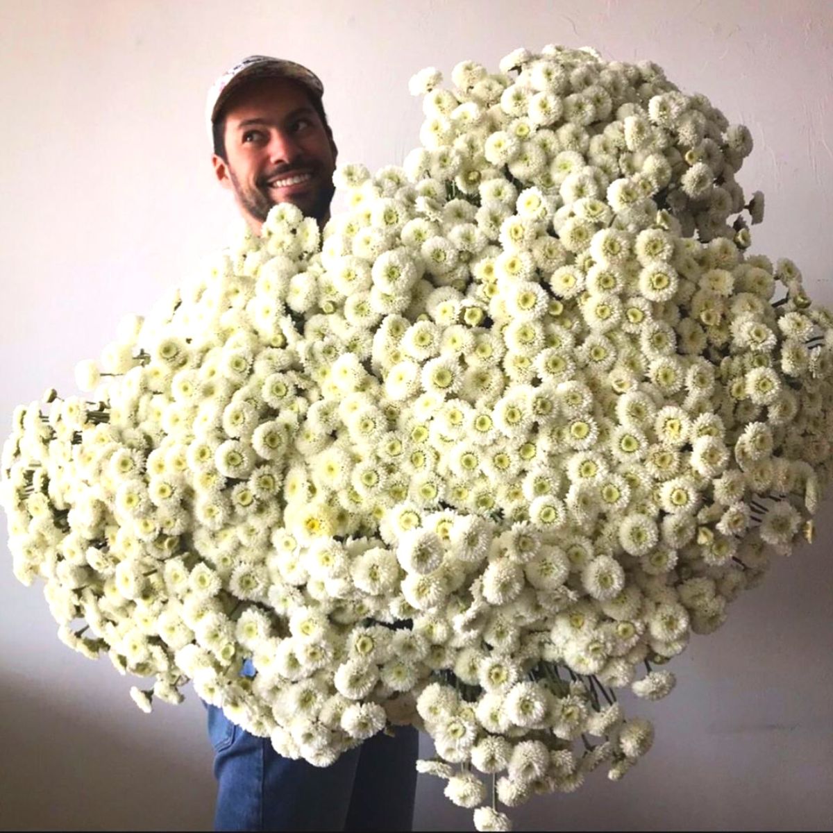 Julio Freitas with white chrysanthemums