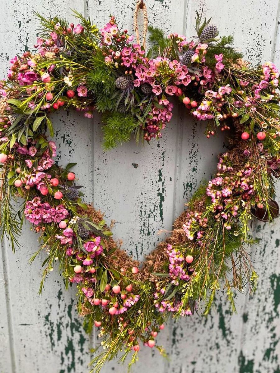 Heart shaped floral wreath with dried flowers and rosehips
