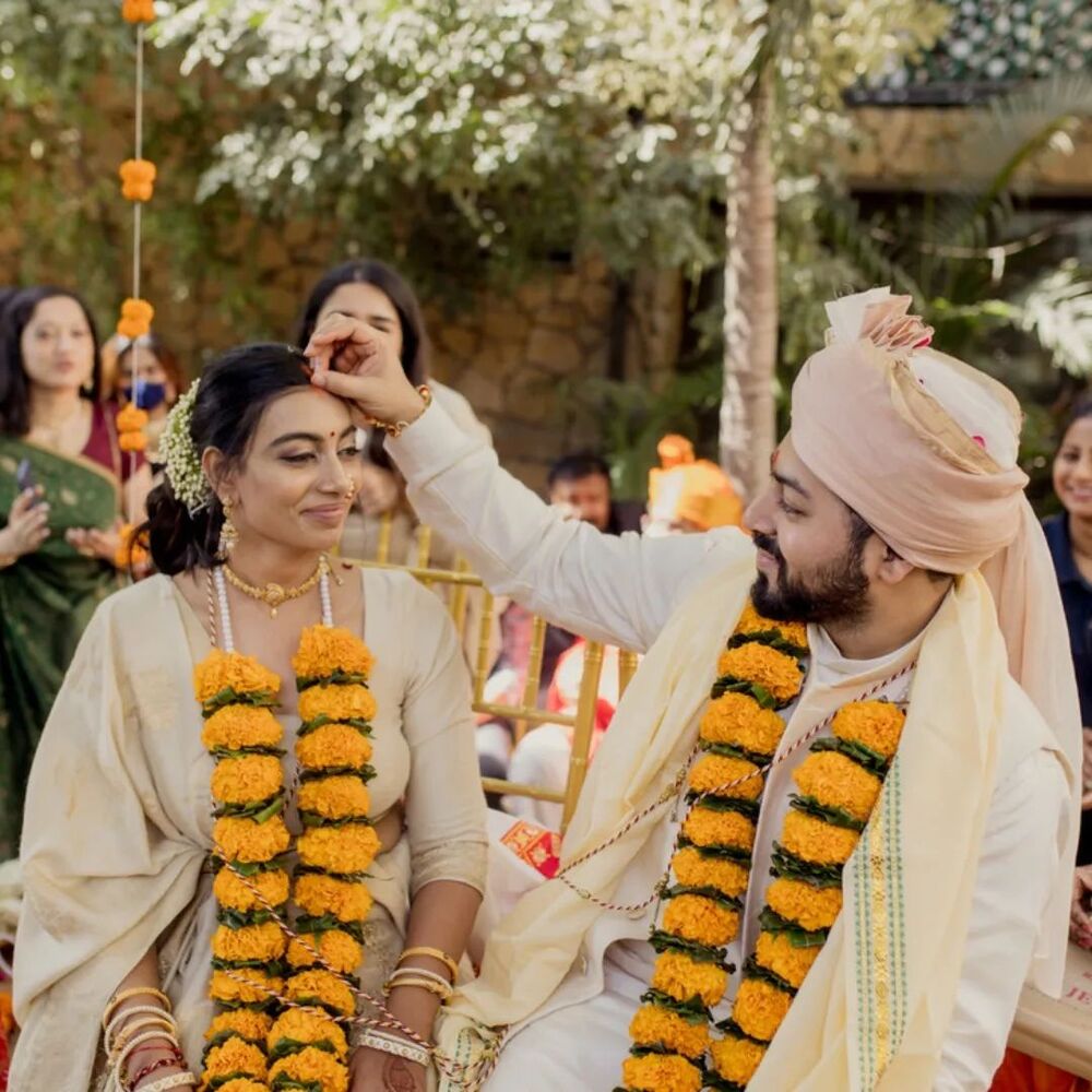 Marigold garland being used as varmala in an Indian wedding varmala in an Indian wedding