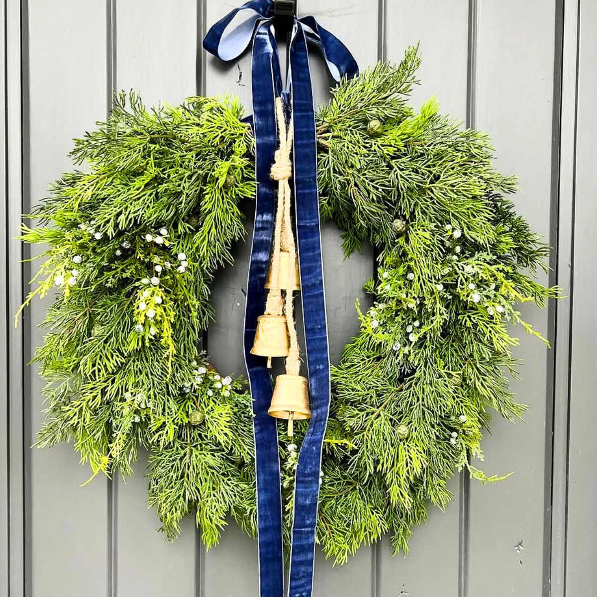 Juniper wreath with bells and blue ribbon Juniper wreath with bells and blue ribbon