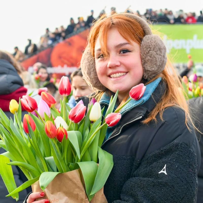 Happy girl with a tulip bouquet Happy girl with a tulip bouquet